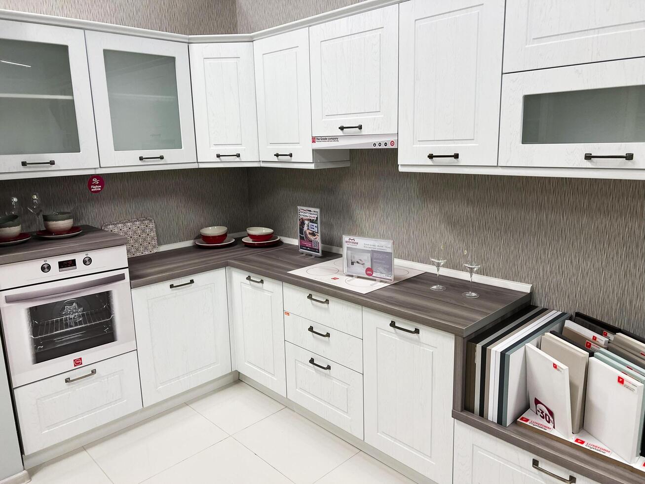 Kyiv, Ukraine - January 03, 2025 Modern white kitchen with wooden countertops and built-in cooking appliances photo