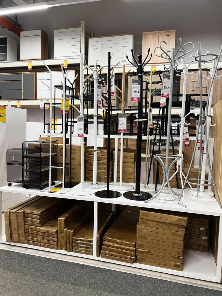 Kyiv, Ukraine - January 03, 2025 Selection of coat racks displayed in furniture store interior with shelving photo