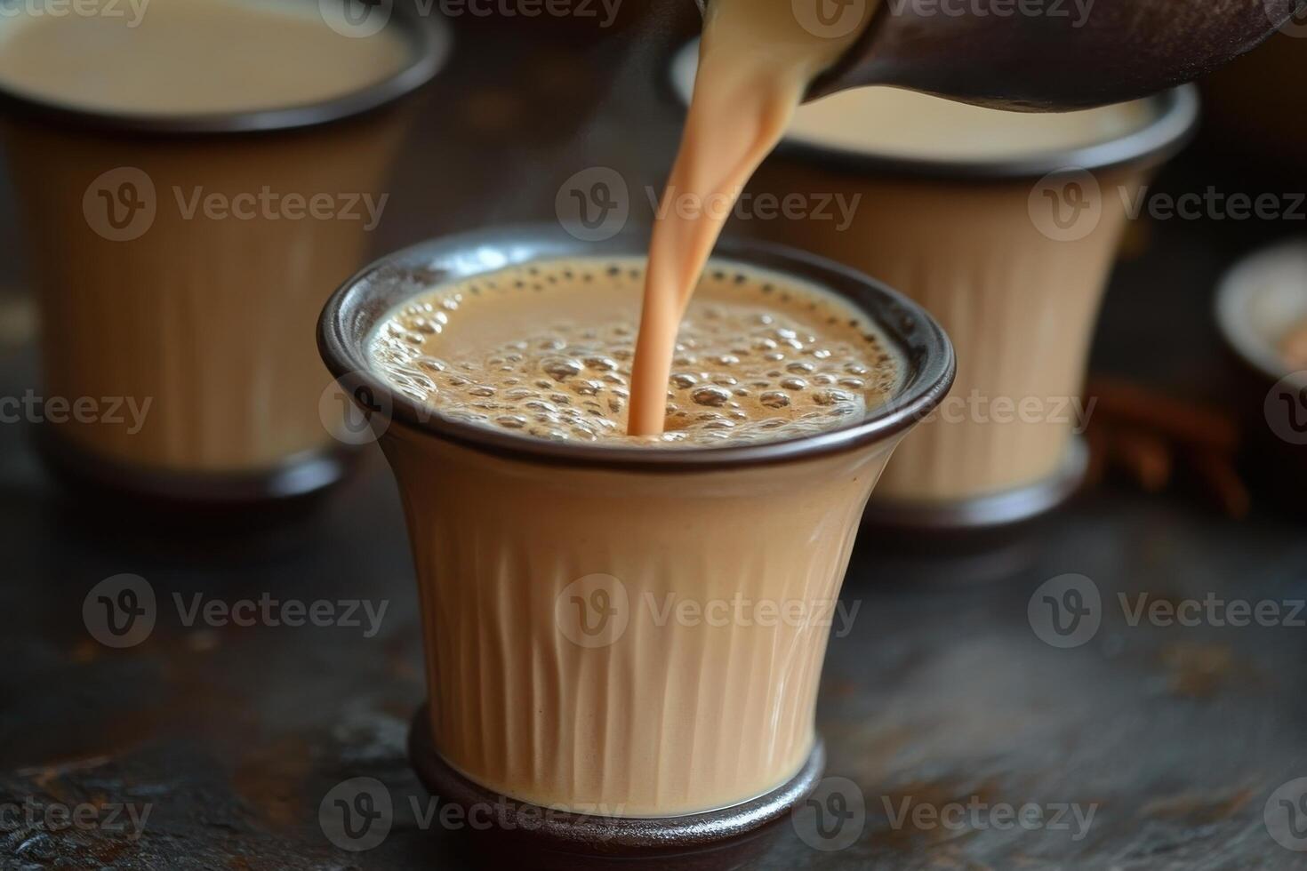 Traditional Masala Chai Tea Poured into a Cup for a Cozy Beverage Experience photo
