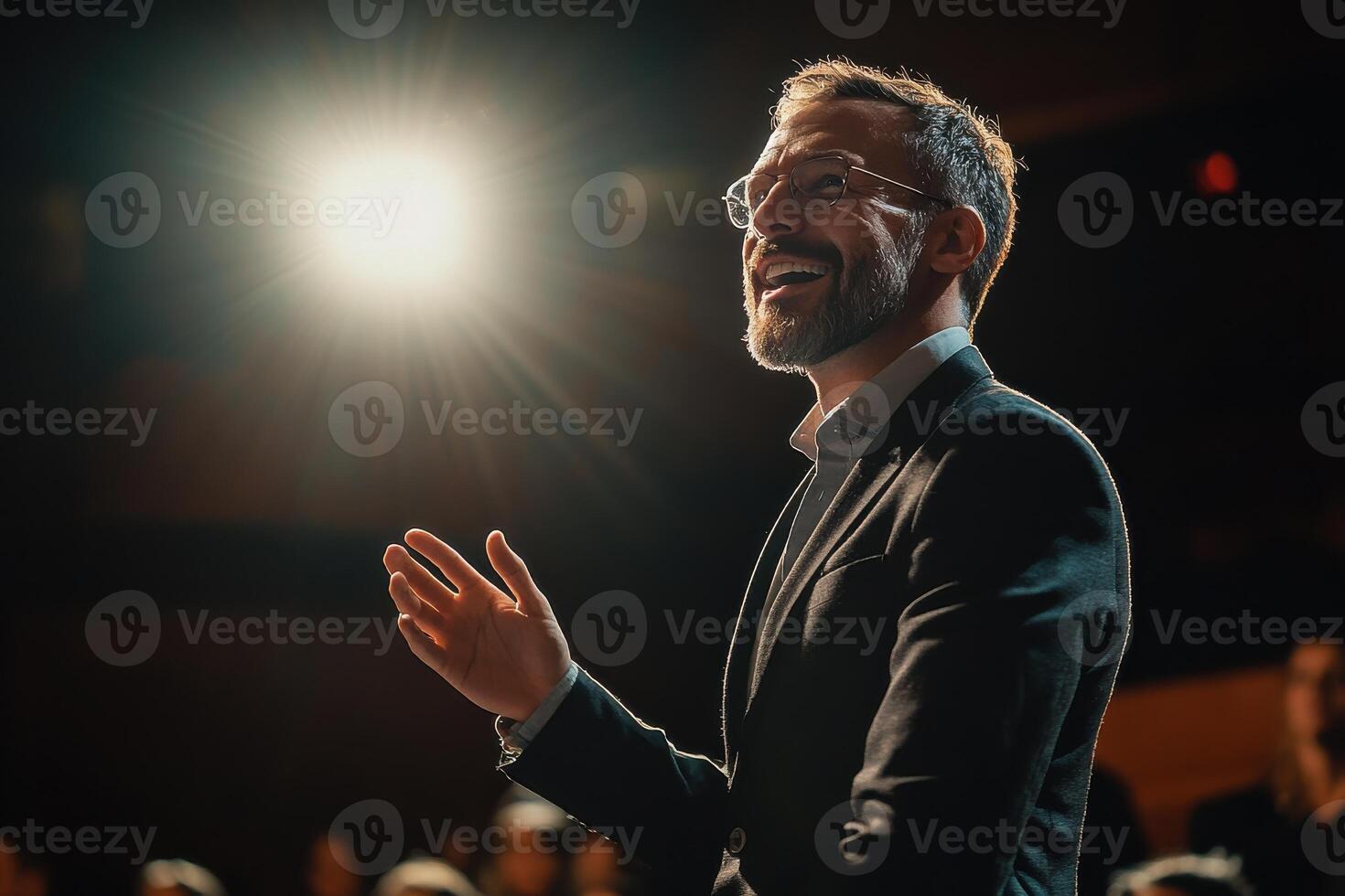 Dynamic Motivational Speaker Inspiring a Large Audience in an Engaging Setting photo