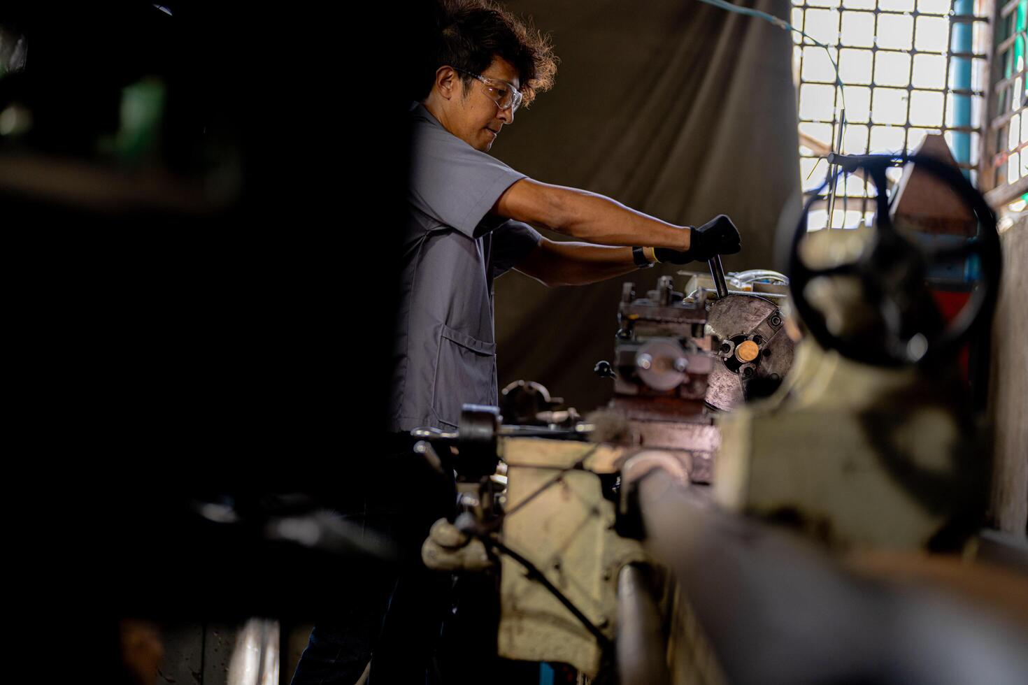 A detailed view of metal lathe operation reveals a steel column rolling smoothly through the machining process. photo