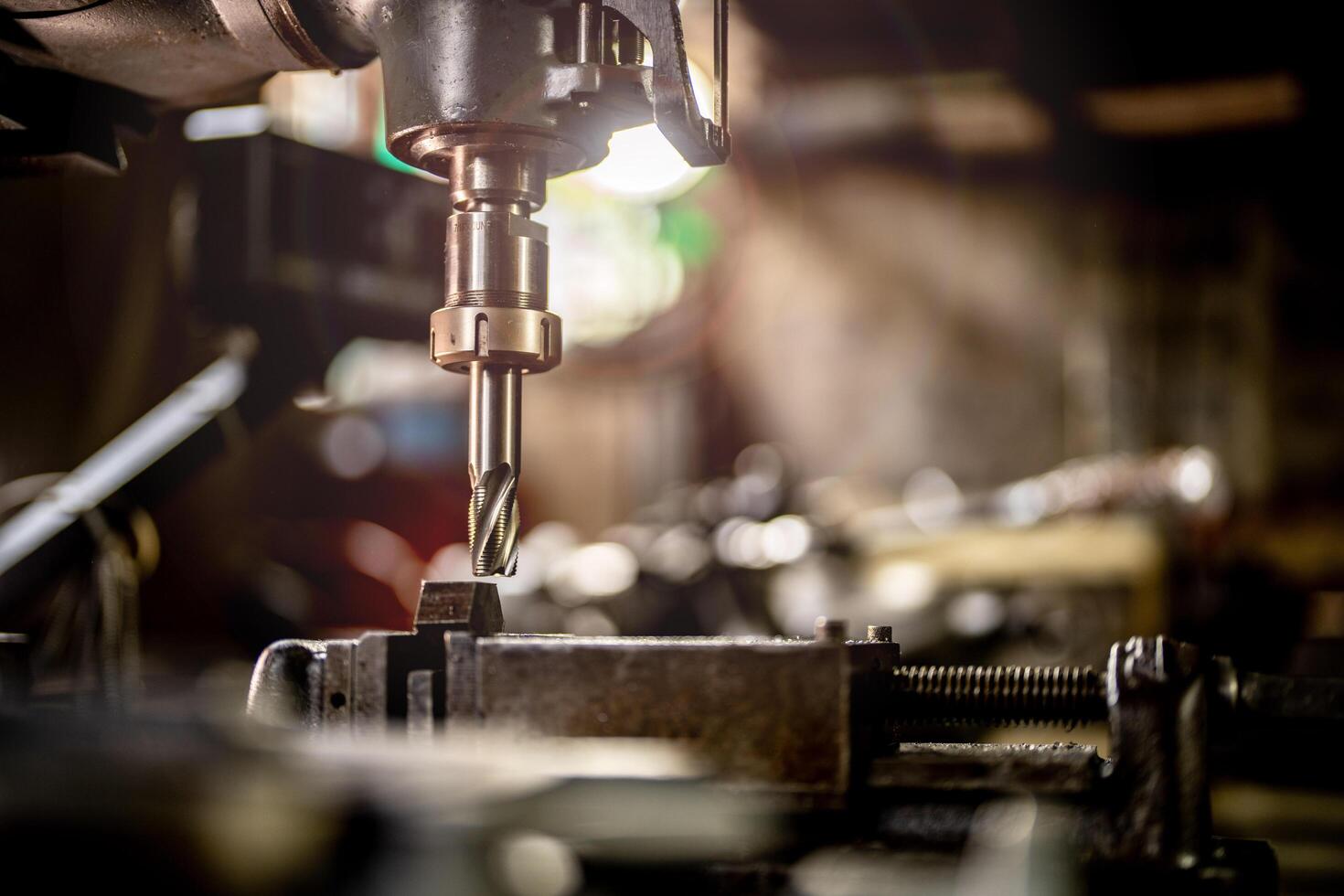 The smooth operation of a lathe grinder machine is displayed as it refines the steel column surface. photo