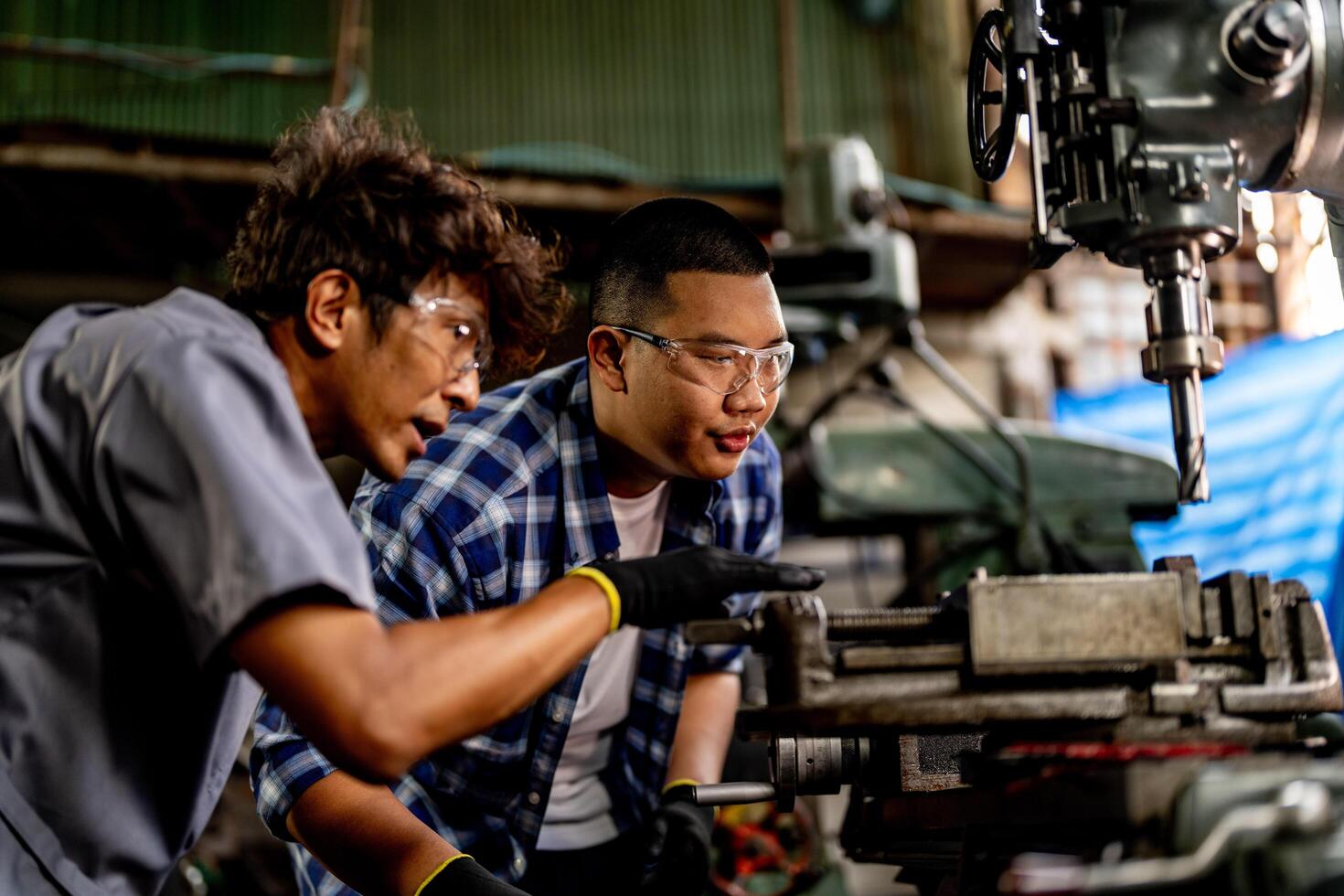 Sparks fly as a worker in a factory finishes the internal surface of a metal part. photo
