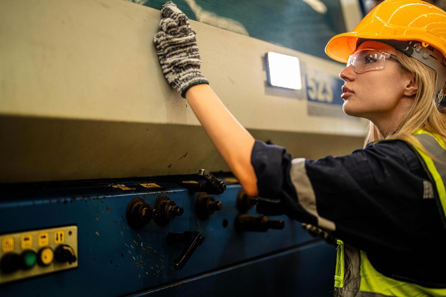 Factory engineer woman standing confidence to control panel switch. Worker works at machine at industry factory. with machinery equipment plant technology. photo