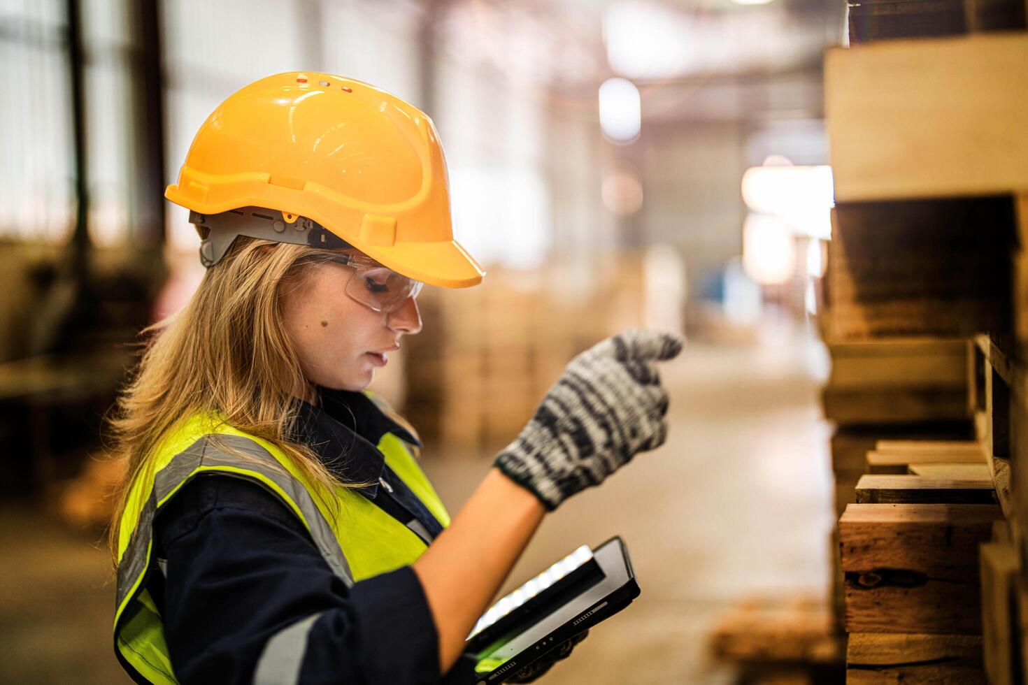 A female carpenter ensures the quality of wooden items during her shift at the manufacturing facility. photo