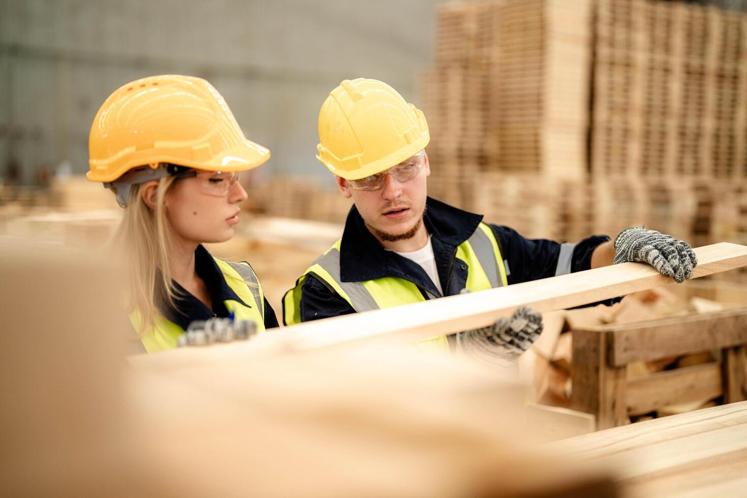 Workers inspect wooden materials during a warehouse tour, ensuring production readiness. photo
