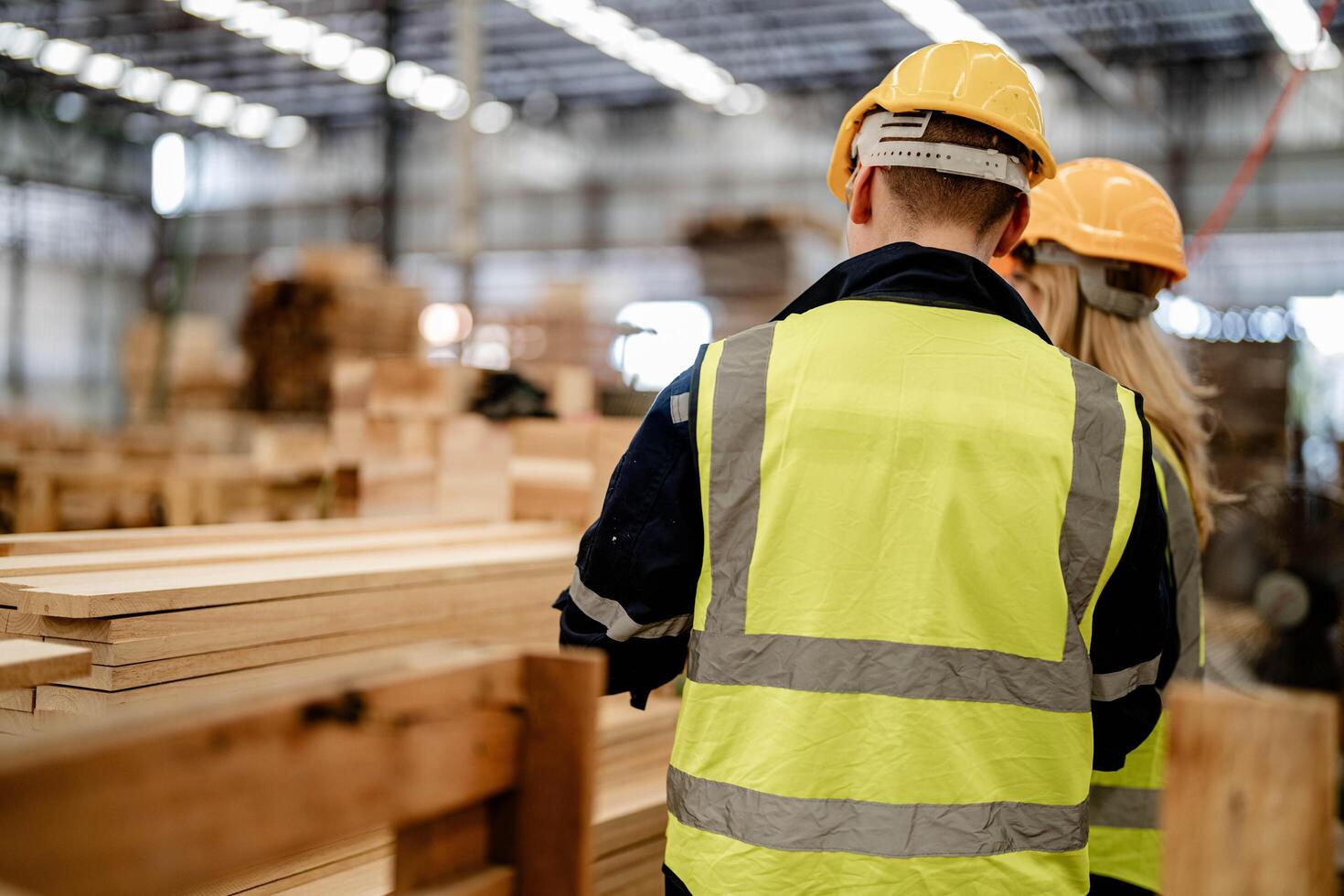 Engineers review wooden timbers during a quality check in the production warehouse. photo