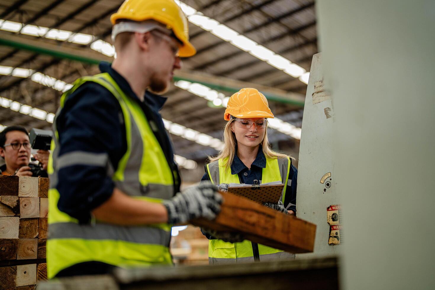 Workers focus on evaluating timber wood during a warehouse inspection process. photo