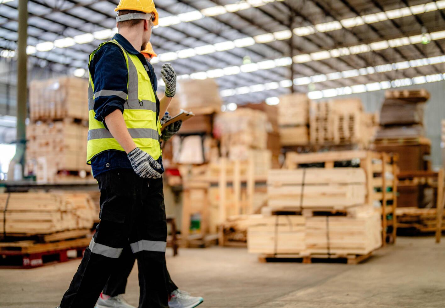 Engineers assess timber wood during an inspection to maintain manufacturing quality. photo