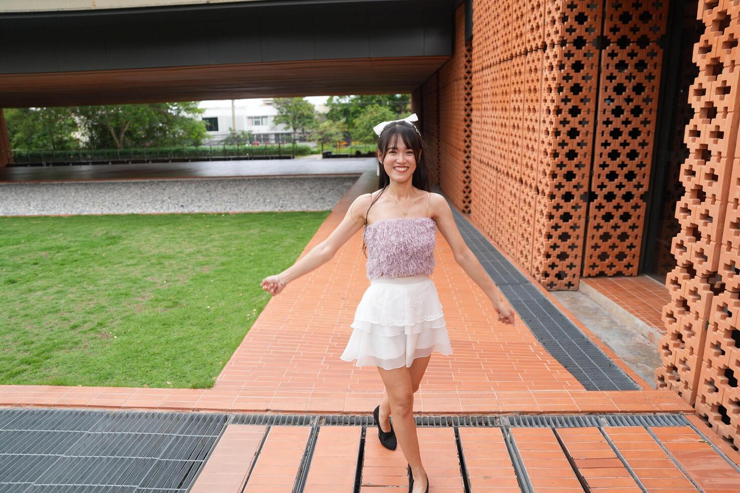 In a calm indoor area, a wom an dances freely near beautiful greenery and a scenic view, radiating harmony and peace. photo