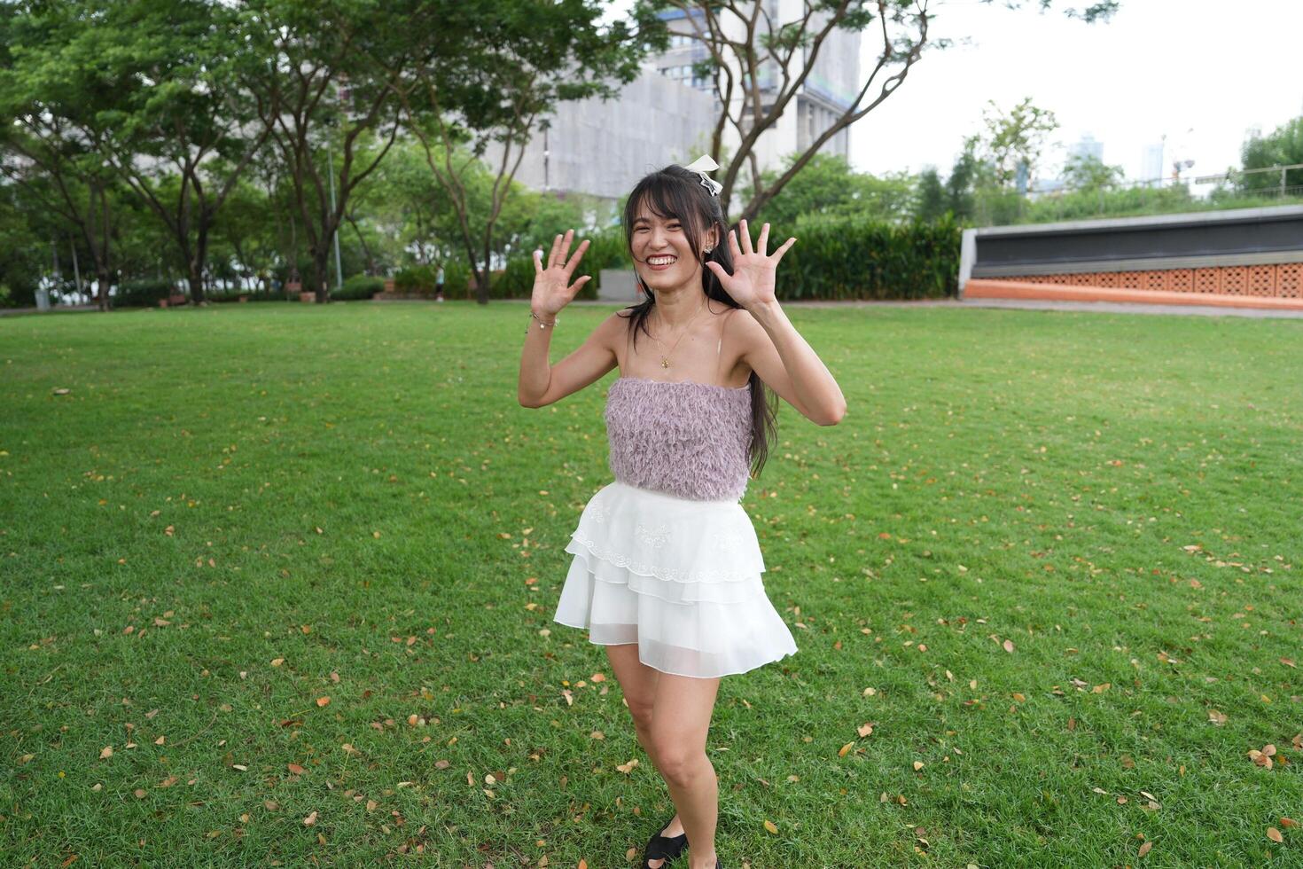 A joyful young woman dances in harmony indoo rs, with large windows and lush plants enhancing the pure joy. photo
