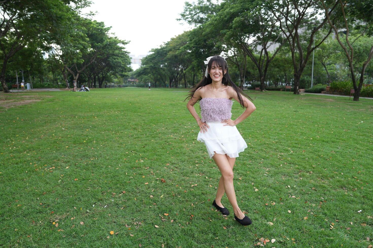 A joyful young woman danc es in harmony indoors, with beautiful greenery and a scenic view enhancing the harmony and peace. photo