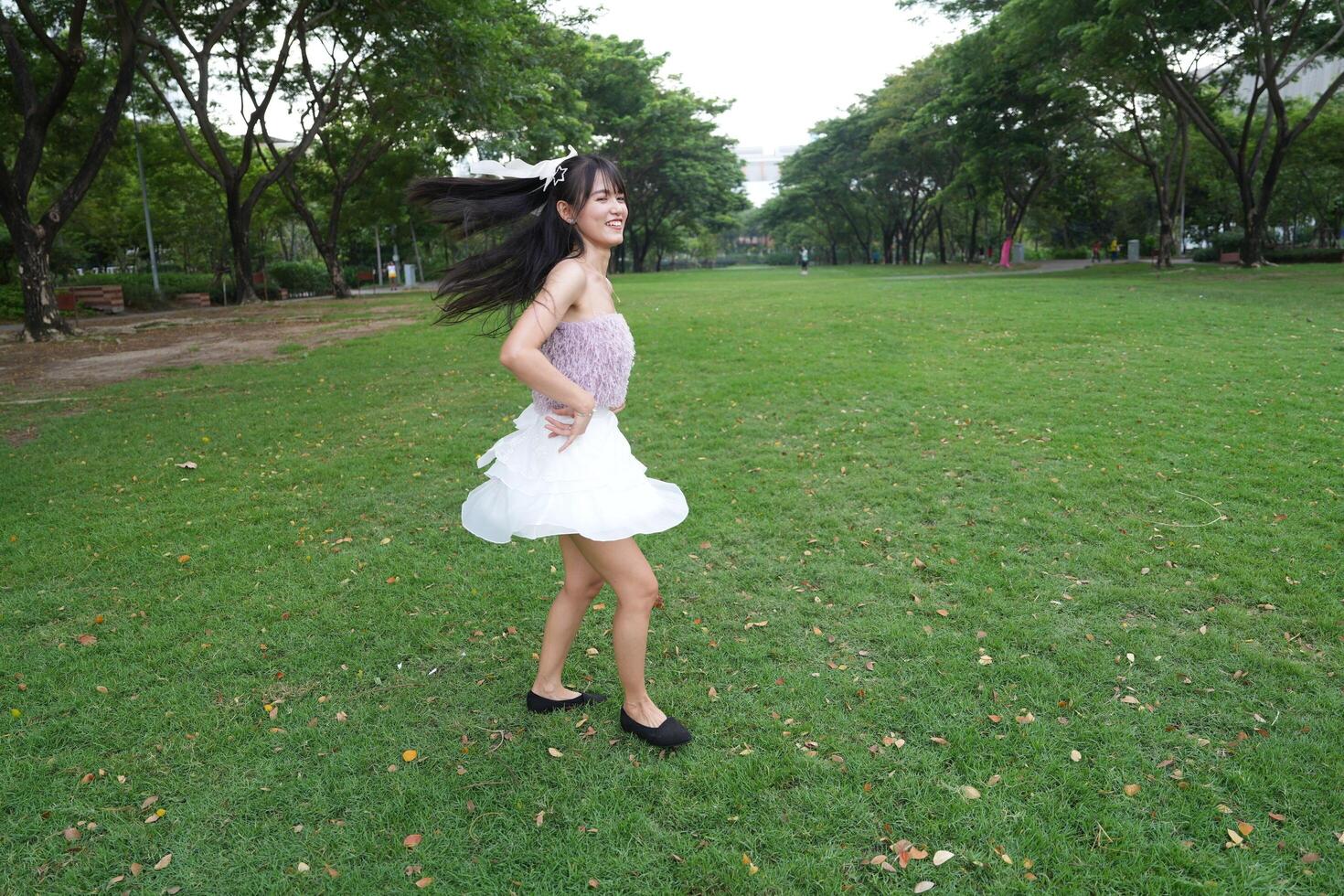 A serene indoor sp ace with beautiful greenery and a scenic view surrounds a dancing woman, capturing freedom and energy. photo