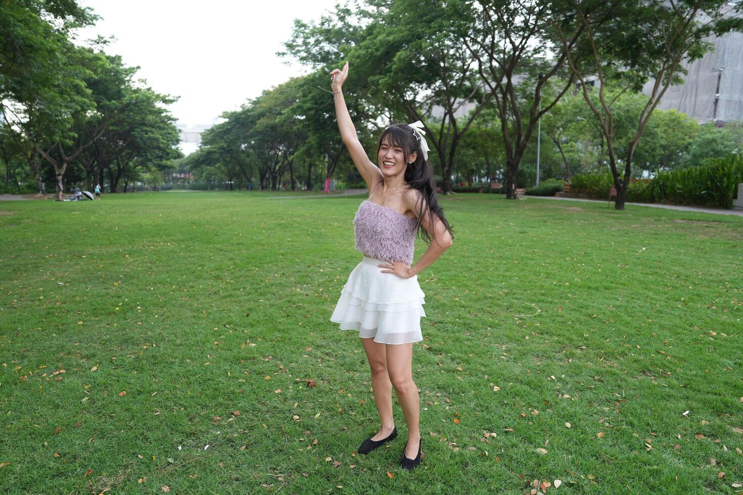 In a calm indoor area, a woman dance s freely near beautiful greenery and a scenic view, radiating harmony and peace. photo
