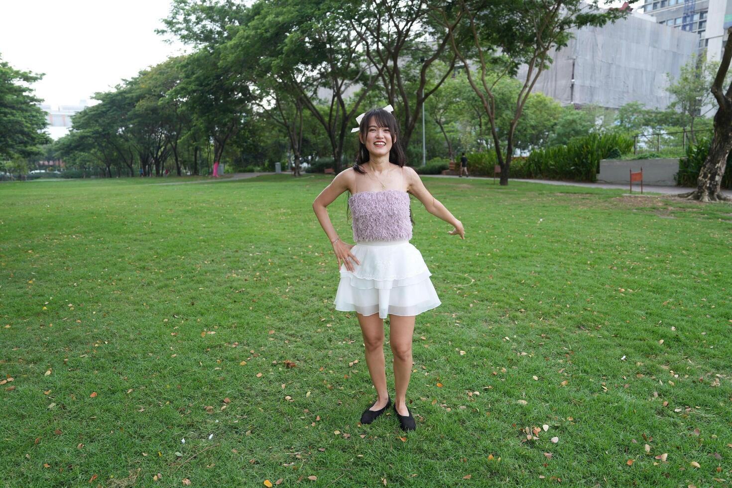 In a calm i ndoor area, a woman dances freely near large windows and a scenic view, radiating freedom and energy. photo