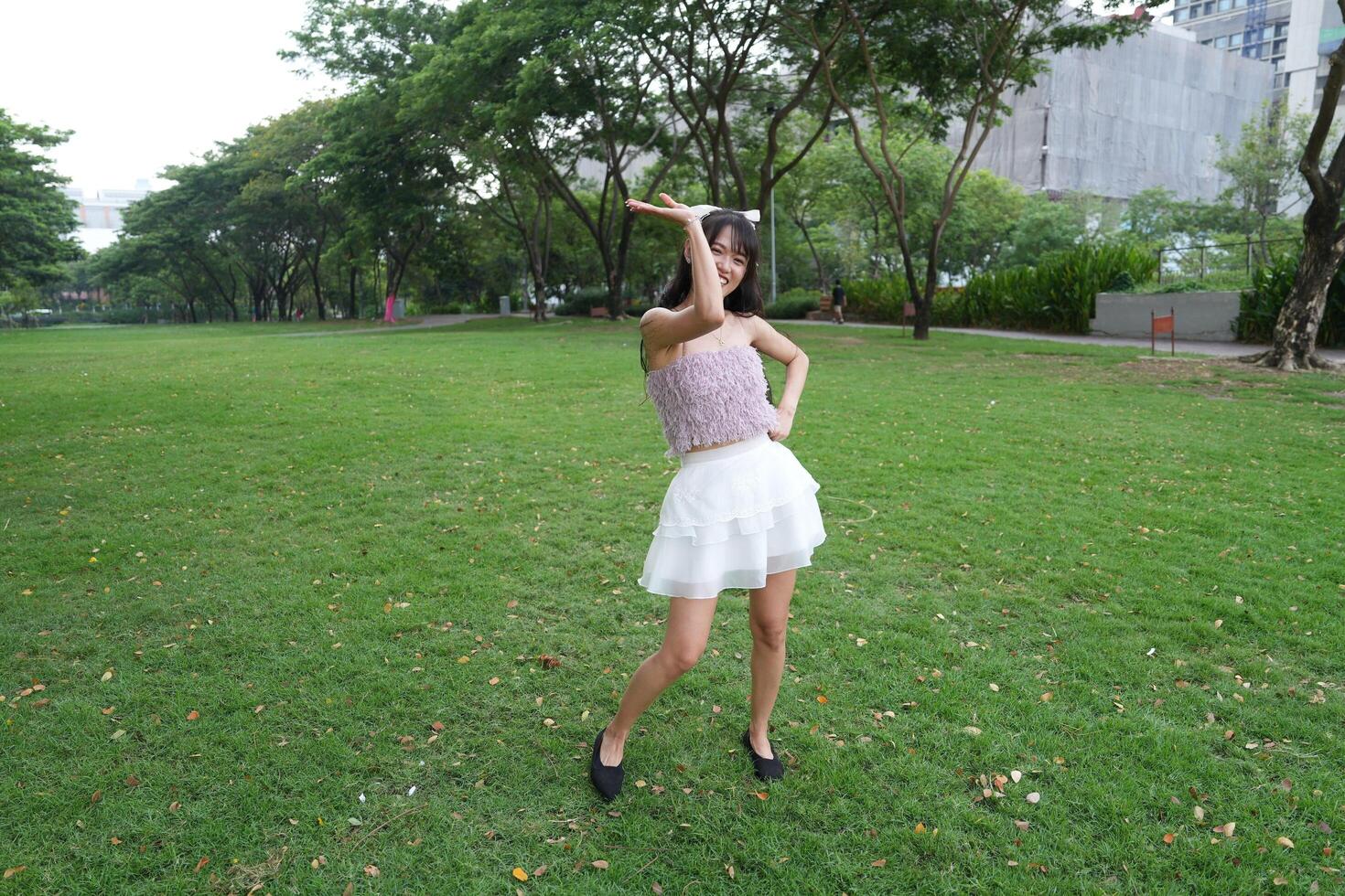 A woman dances happily indoo rs, set against large windows and lush plants, symbolizing harmony and peace. photo