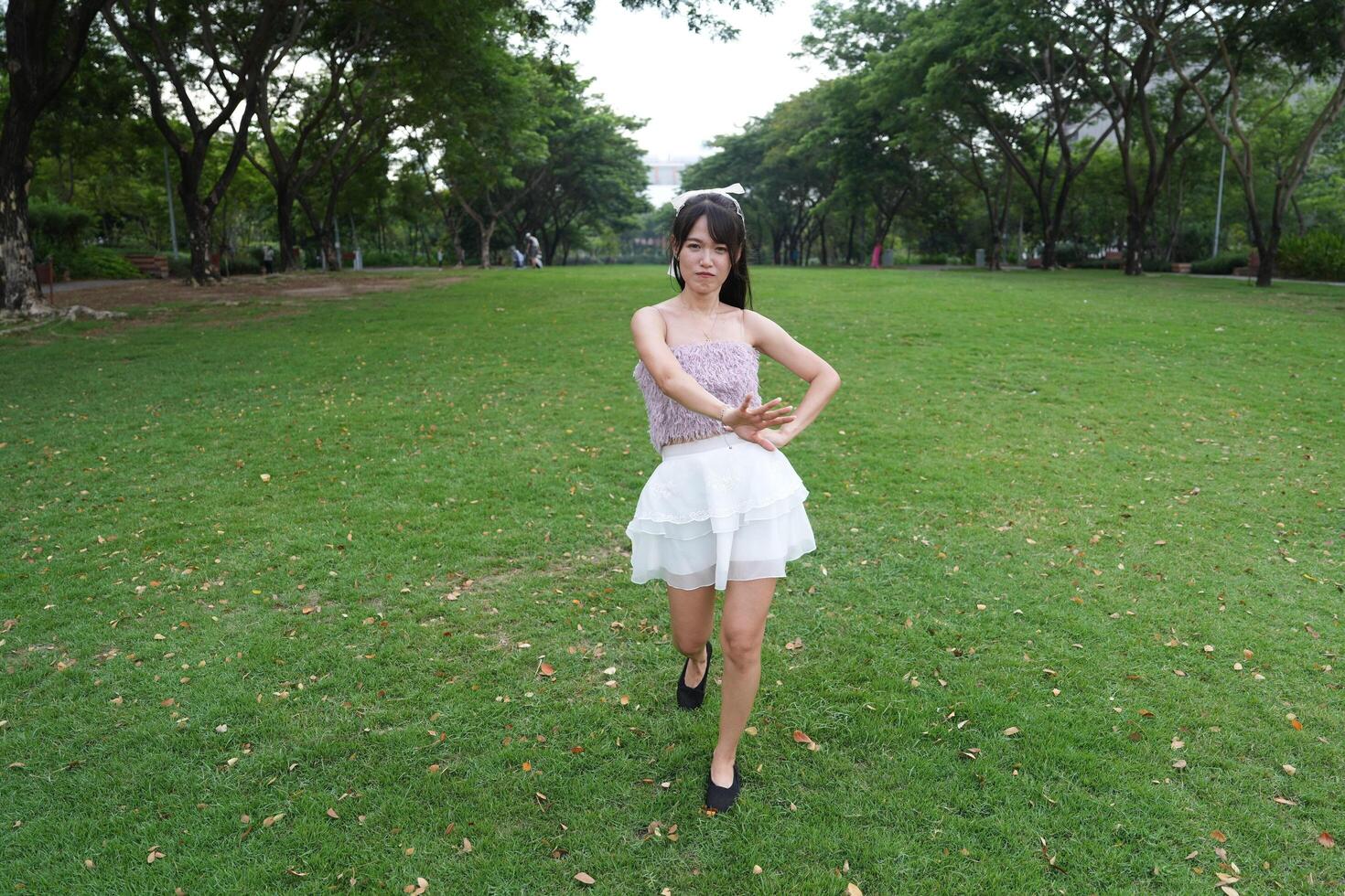 A wo man dances happily indoors, set against large windows and a scenic view, symbolizing harmony and peace. photo