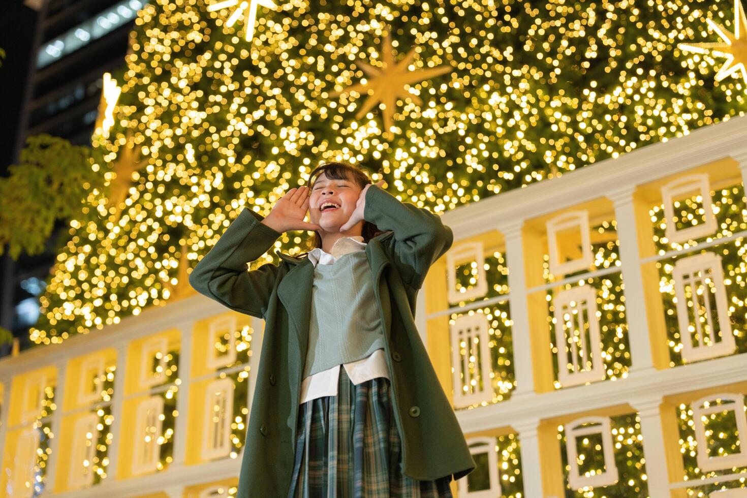 A young woman outdoors in a green coat, photo