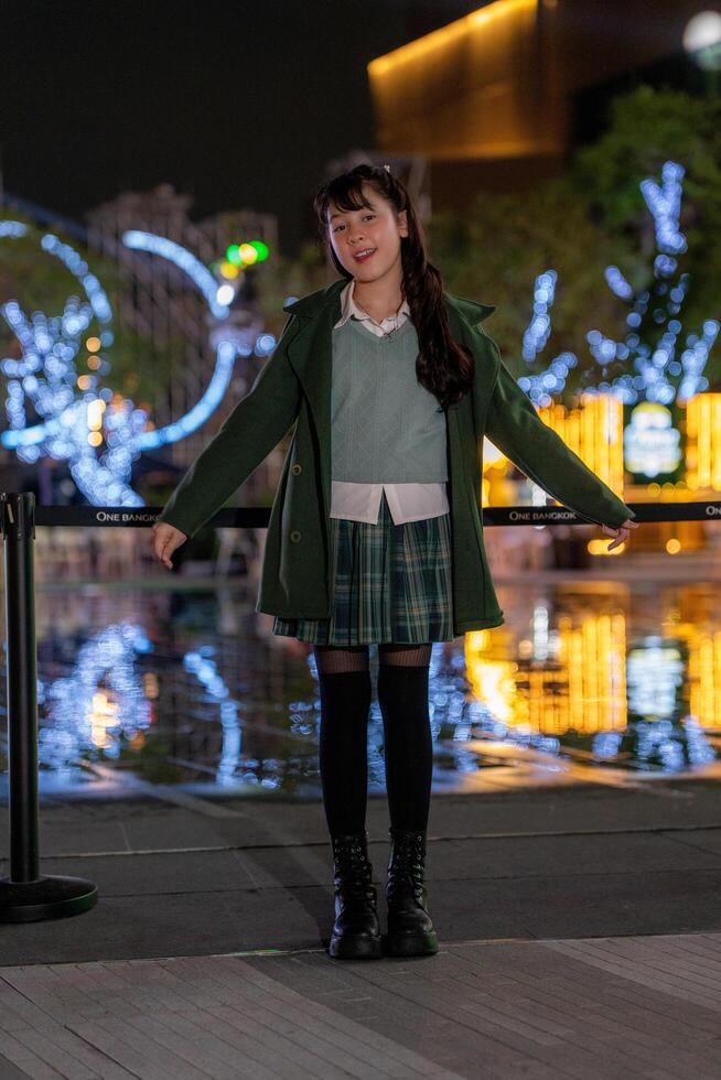 a woman standing in front of a sign that says over the top christmas... photo