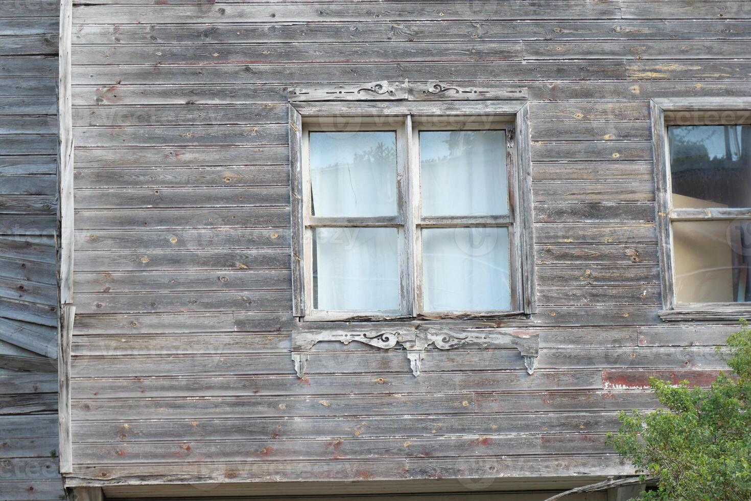Old Weathered Building with Distressed Wooden Siding and Windows photo