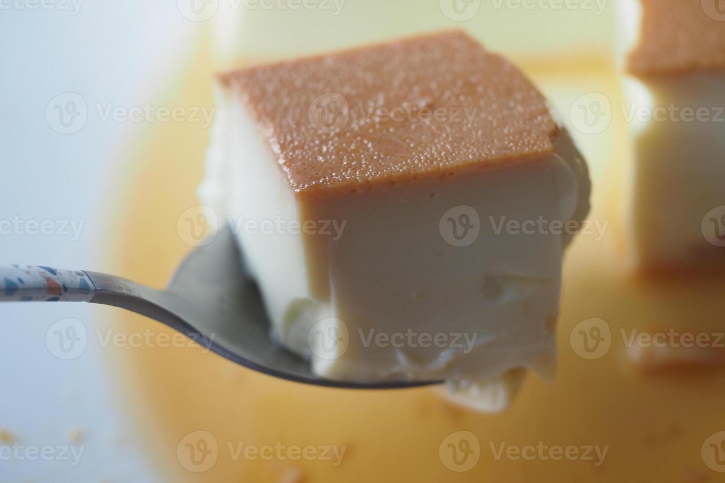 Caramel custard pudding on a plate on table photo