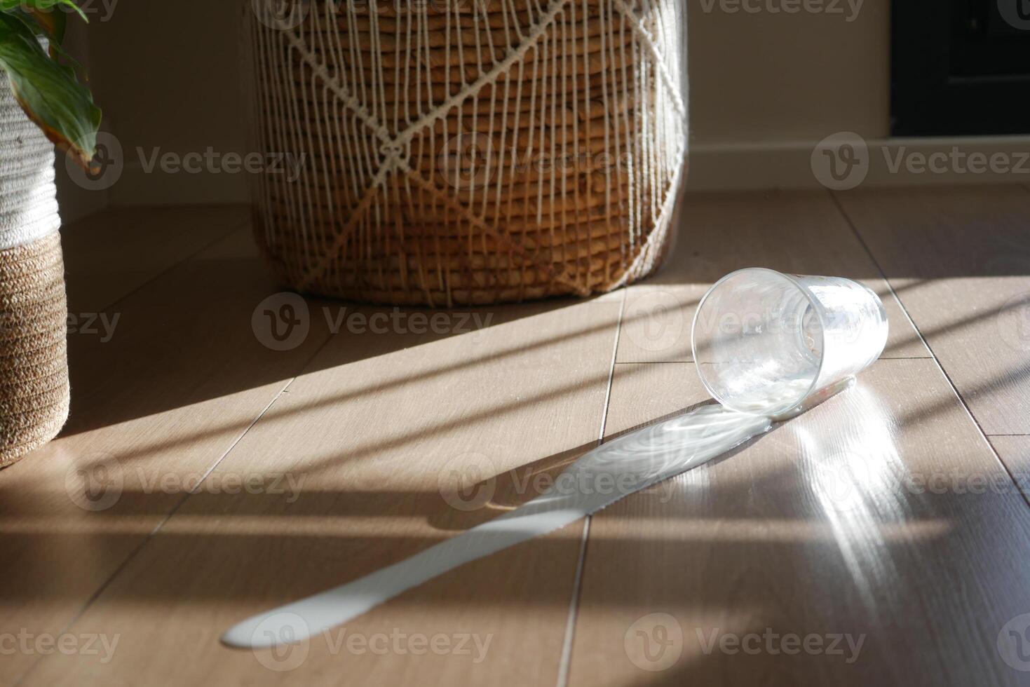 Spilled white milk on a wooden floor , photo