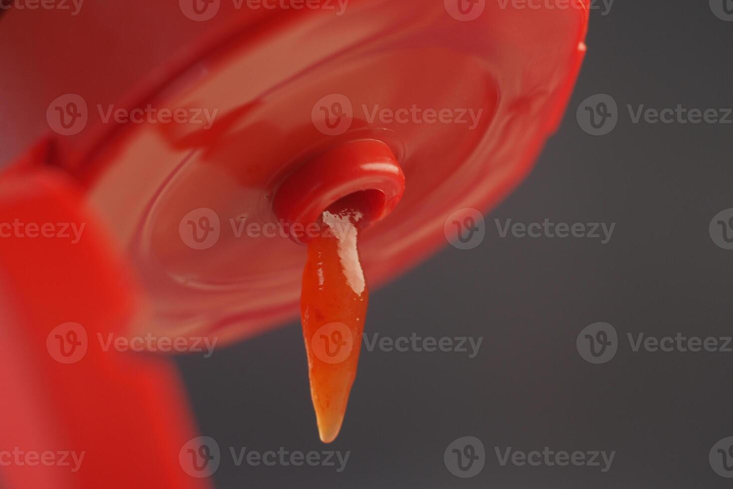A CloseUp of a Ketchup Bottle that has an Open Lid Ready to Use for Dipping and Adding Flavor photo