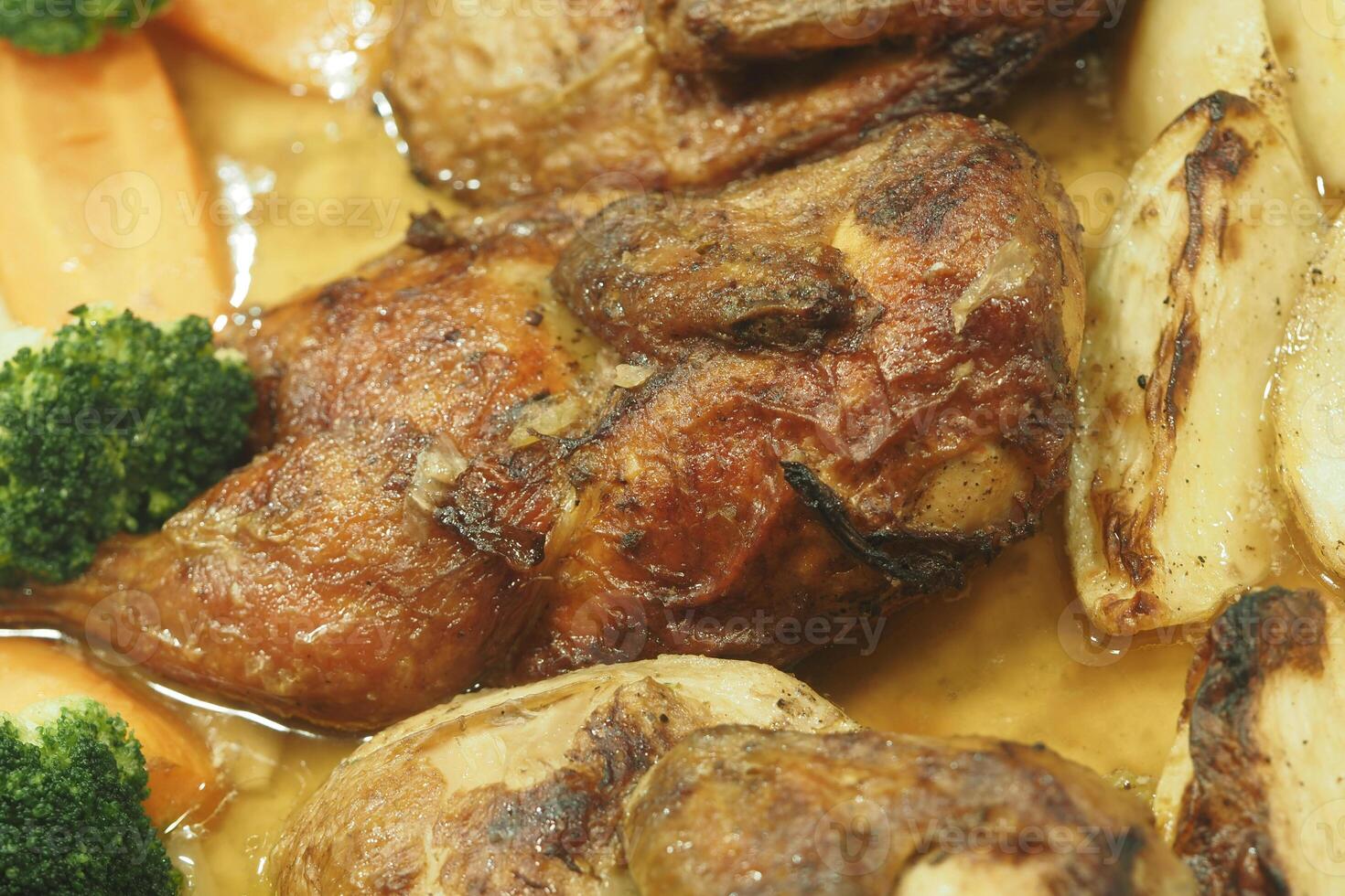 Roasted Chicken accompanied by Vegetables and rich Gravy for dining photo