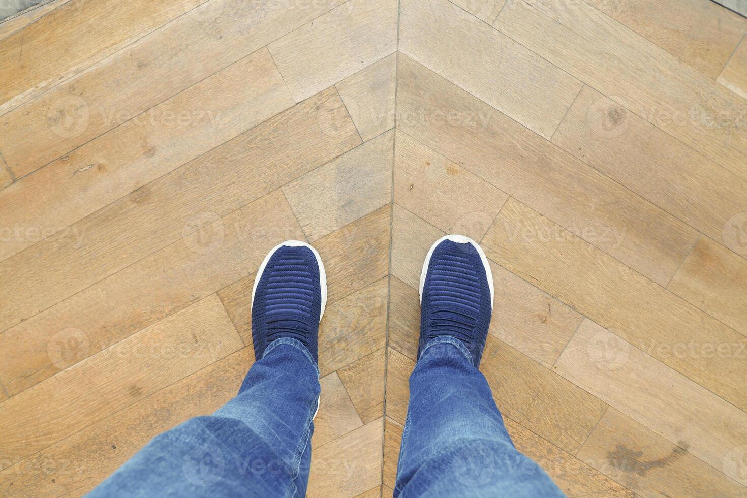 Footwear placed at an angle on a Wooden Herringbone Floor design photo