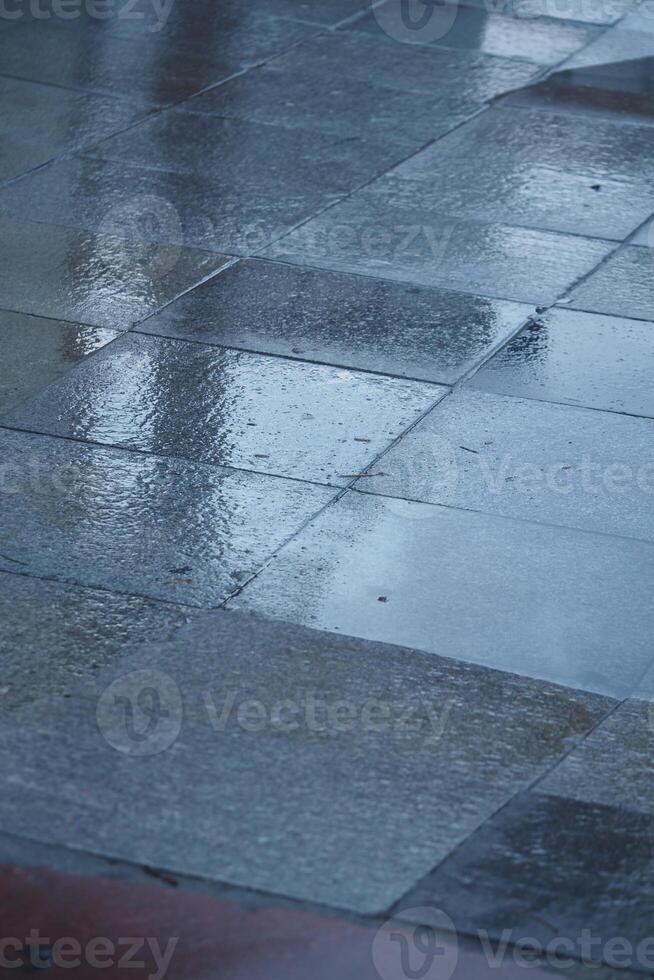 Wet tiles displaying reflections beautifully on a surface during rain photo