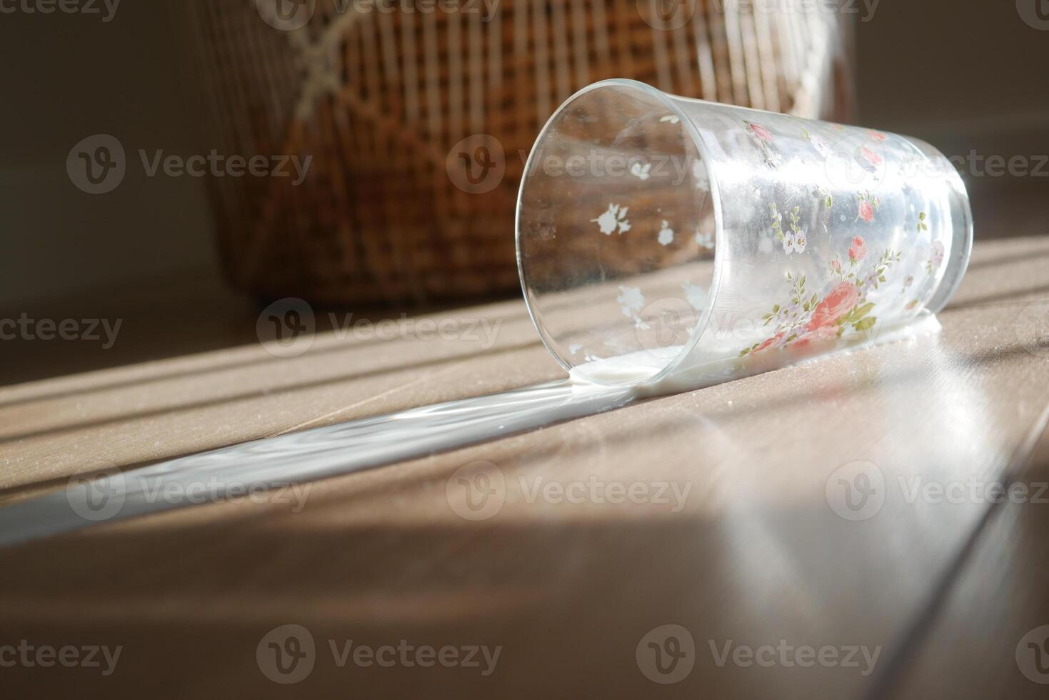 A Spilled Glass Accident on the Floor Casts Beautiful Sunlight Shadows photo