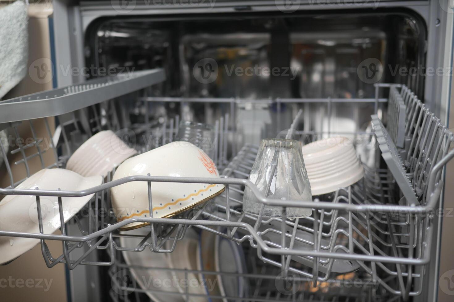 The Dishwasher is Fully Loaded with Sparkling Clean Dishes and Bowls Now photo