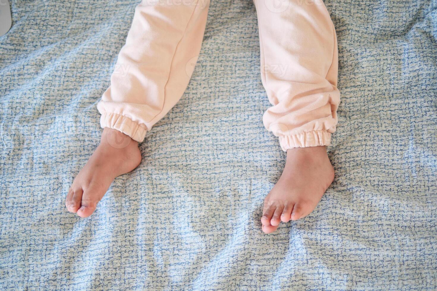 A Childs Cozy Little Feet Relaxing Comfortably on a Soft Blanket photo