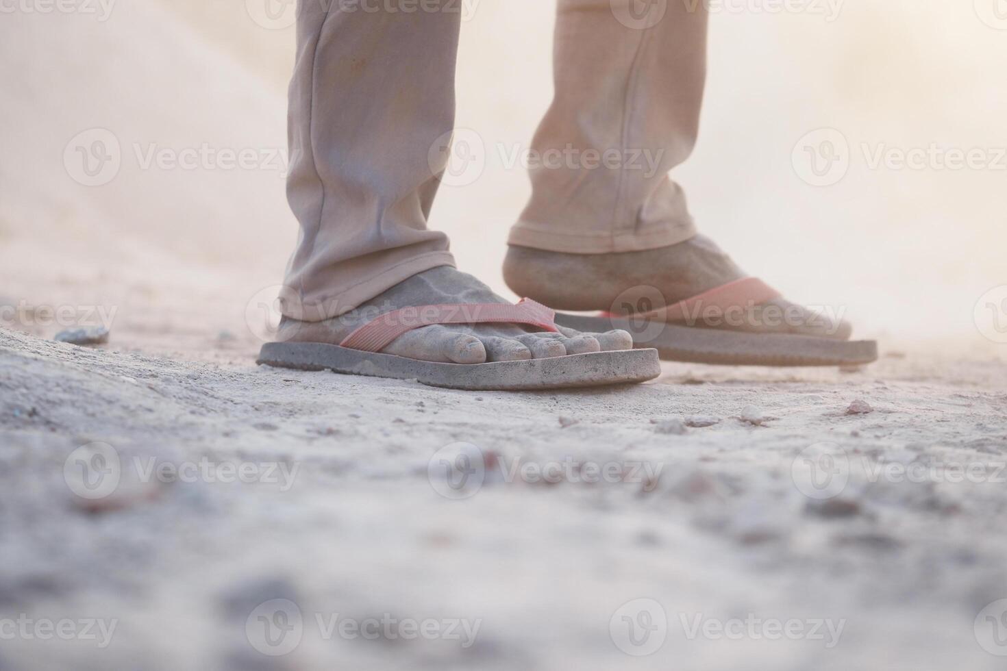 Worn Flip Flops Sitting on Dusty Ground in a Natural Outdoor Setting photo