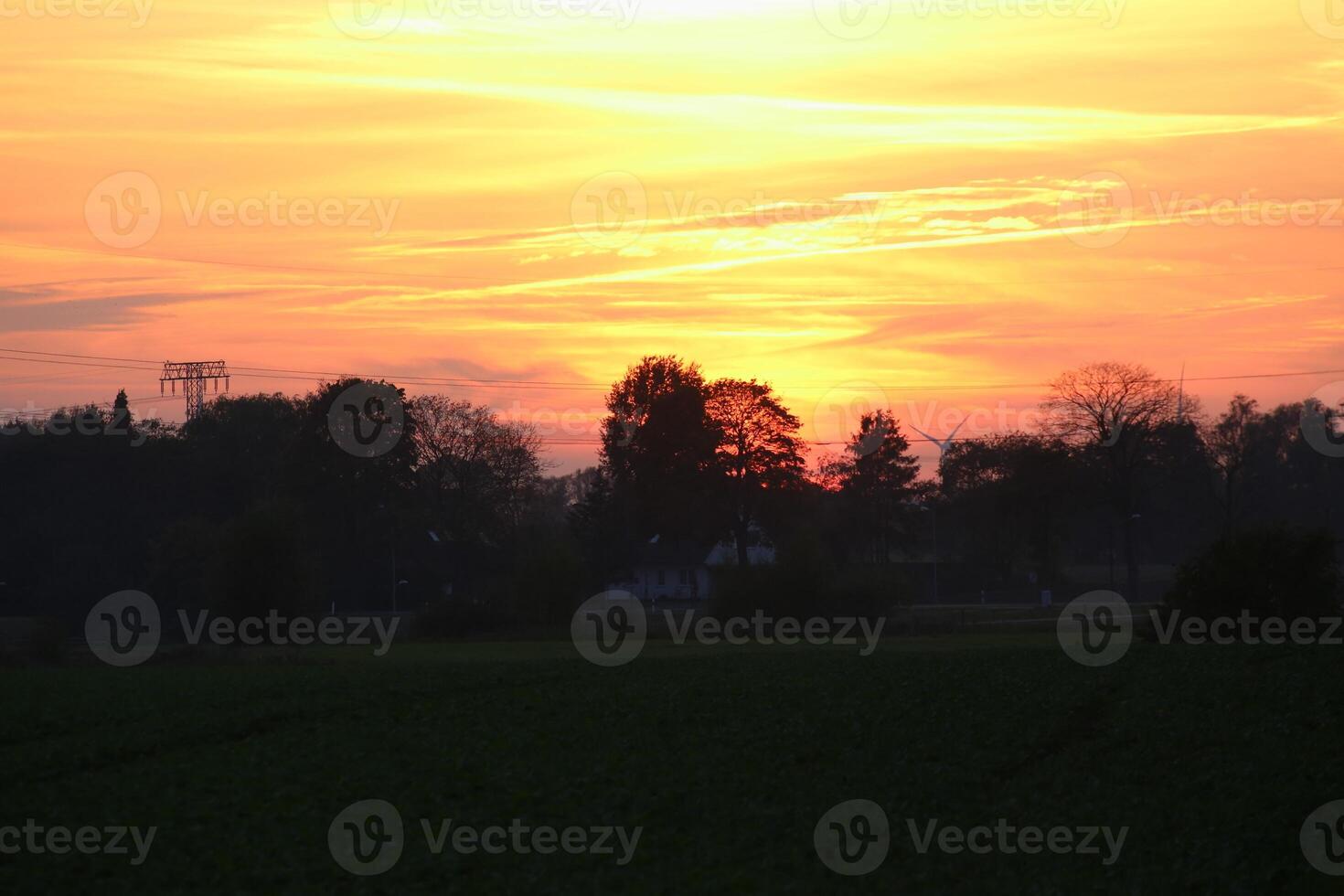 Agricultural lanscape in Mecklenburg-Vorpommern, Germany, under a burning evening sky. photo