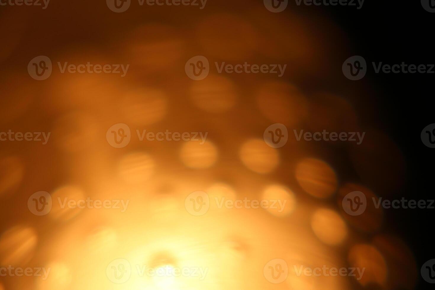 Abstract background of blurry illuminated yellow bubbles. photo