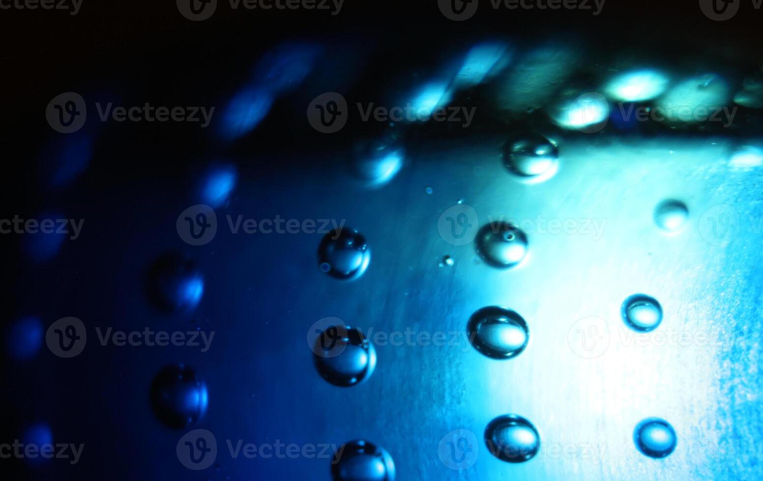 Abstract background of illuminated blue bubbles. photo