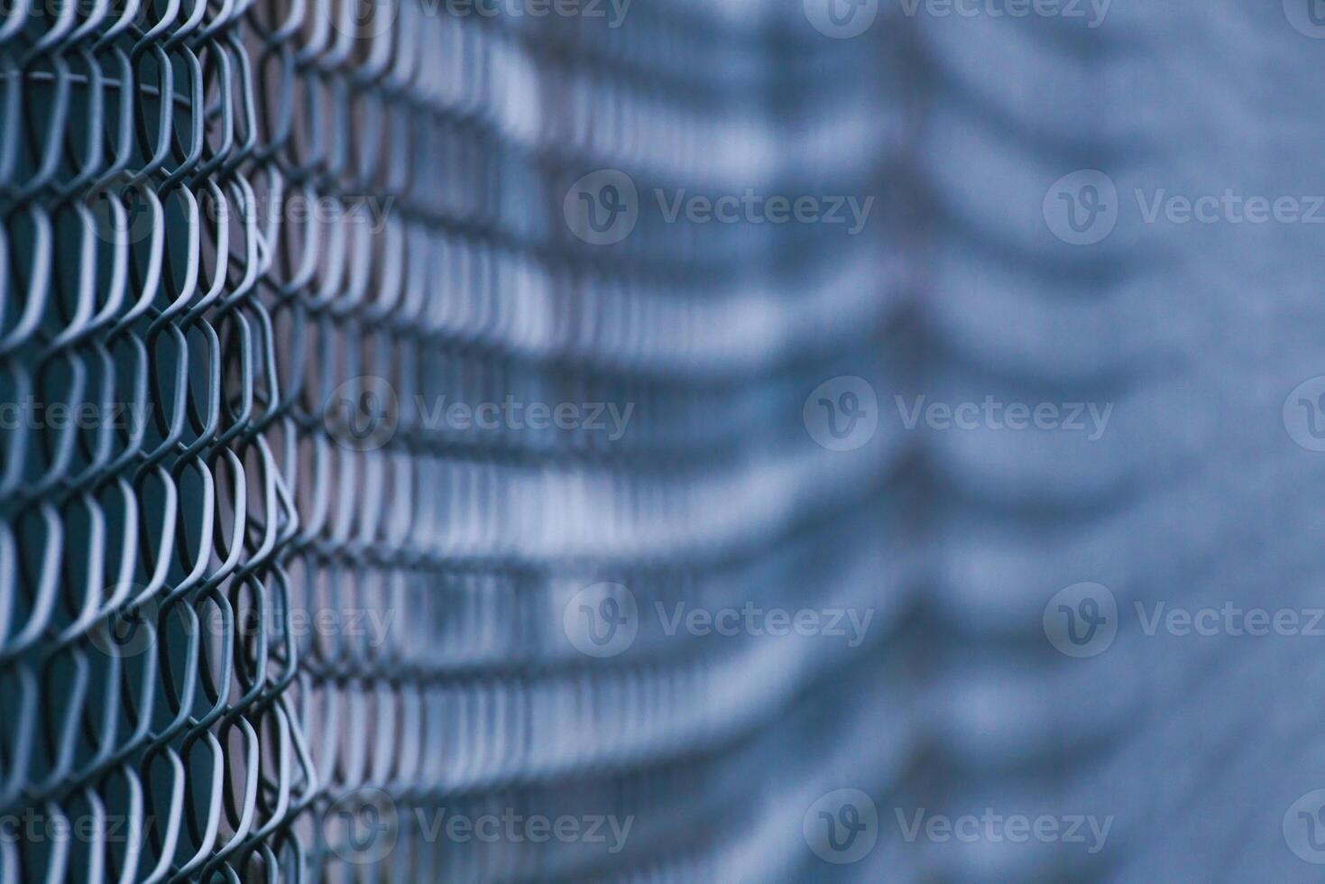 Abstract shot of green wire mesh fence with defocusing effect photo