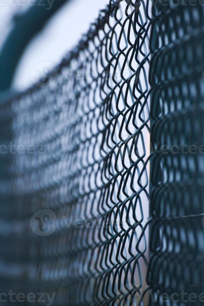 Abstract shot of a green wire mesh fence with defocusing effect photo