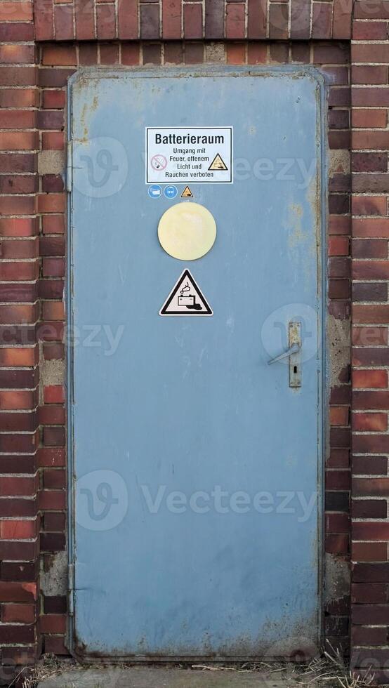 Battery room with with warning sign and various symbols. The text means - Battery room - Fire, open flame, and smoking are forbidden. photo