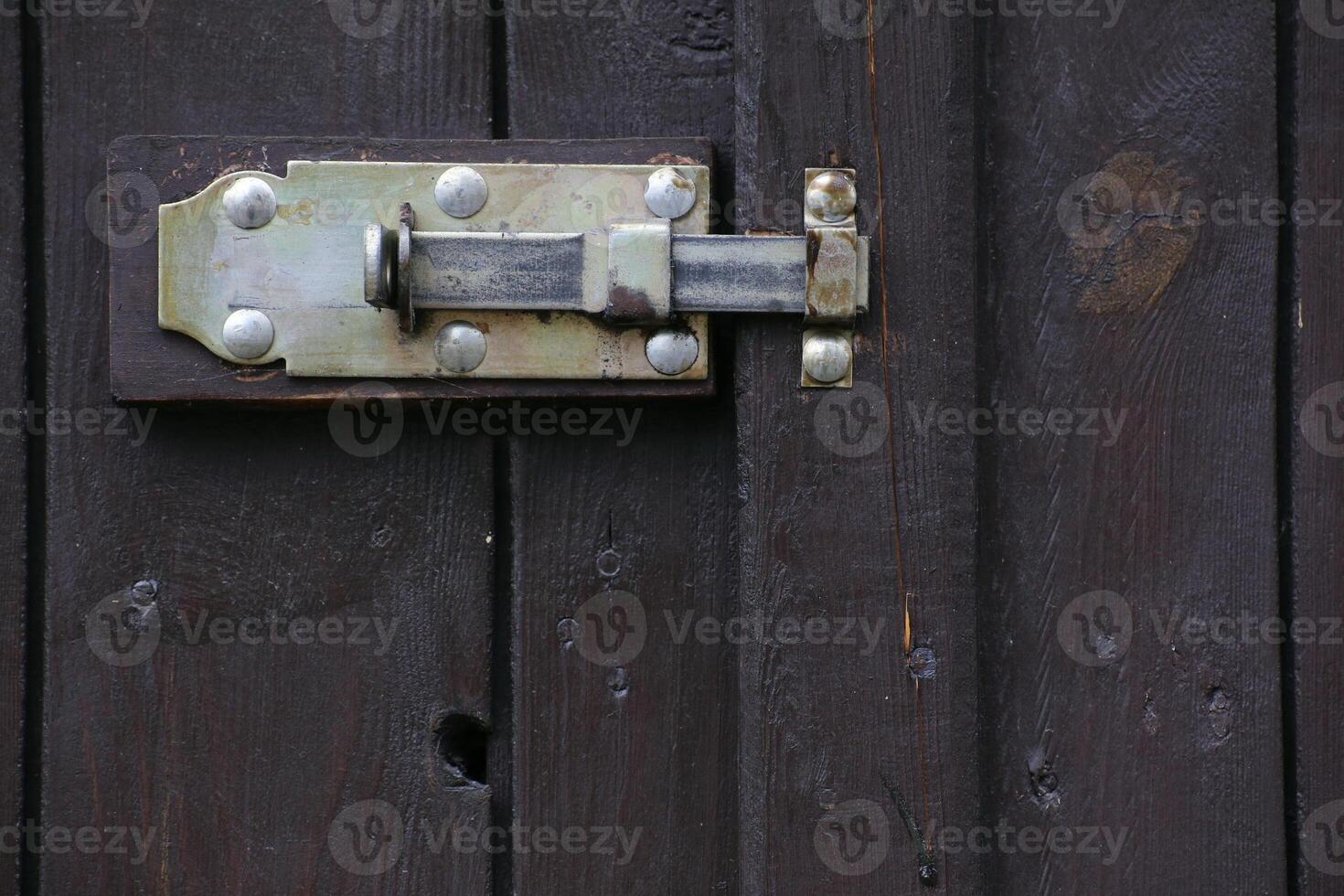 Door latch hanging at the outside of a gate. photo