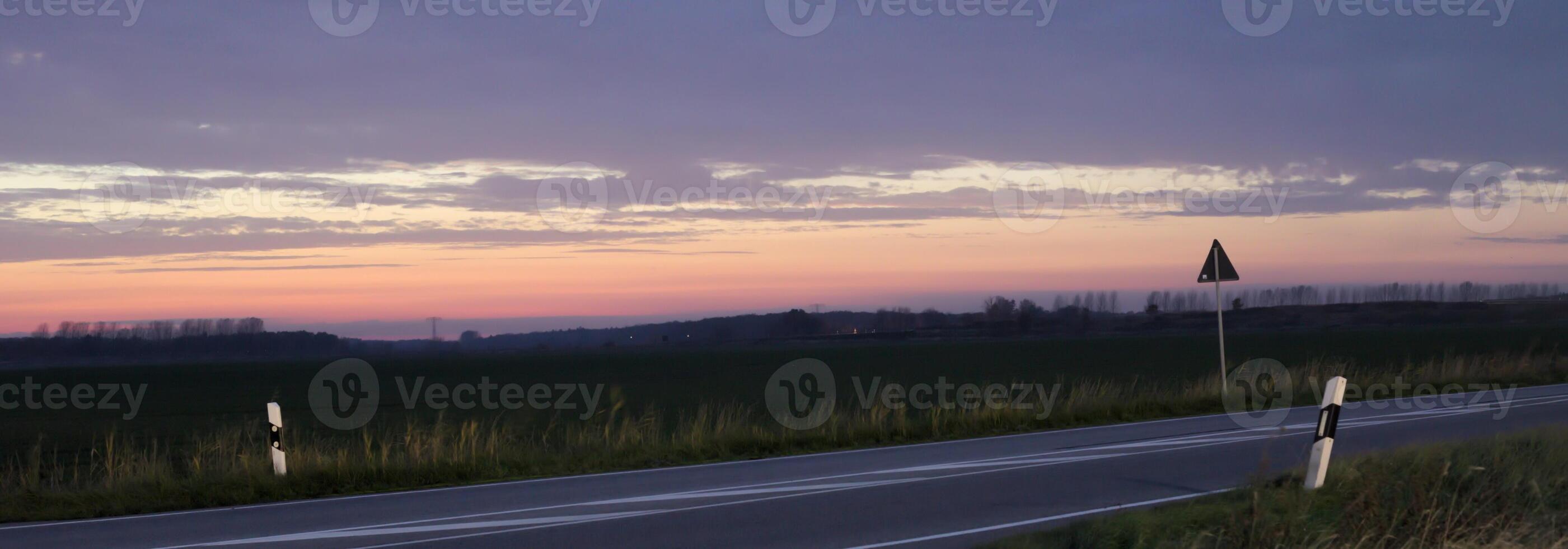 Sunset over a federal road - Bundesstrasse - near Greifswald, Mecklenburg-Vorpommern, Germany. photo