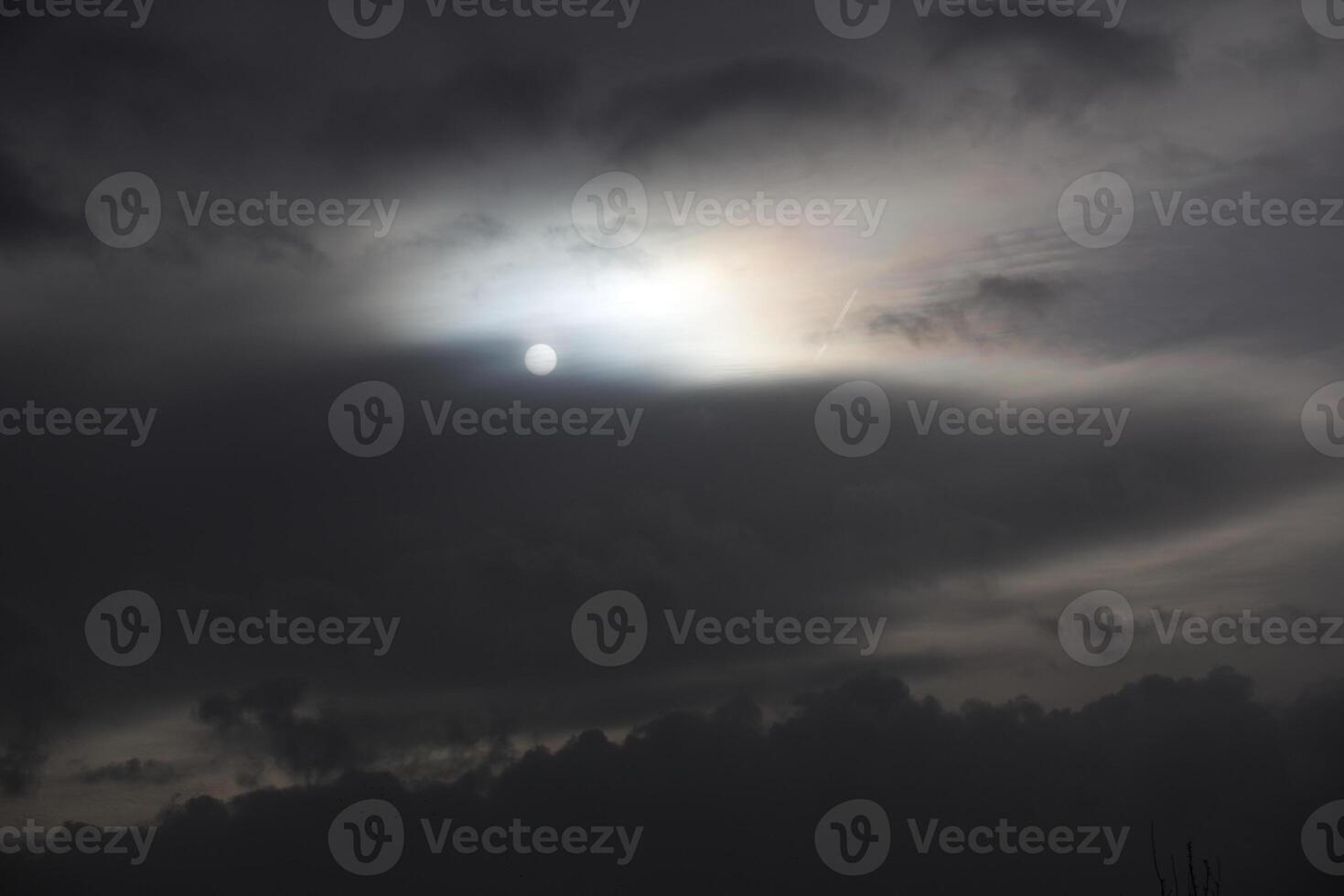 Sun shining through an impressive and dense cloudscape. photo