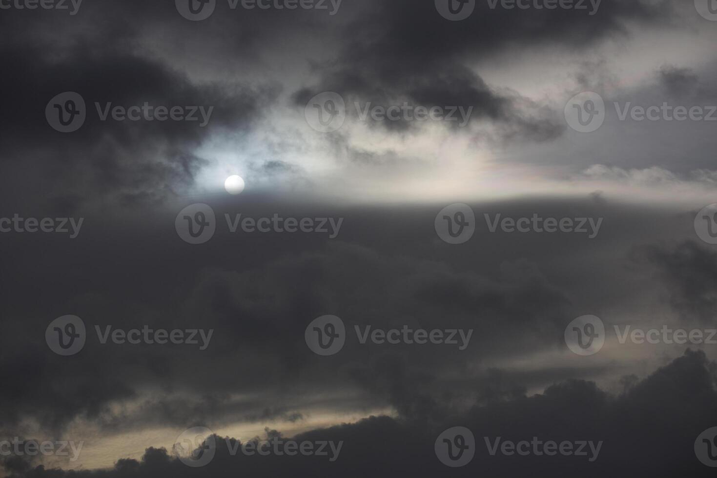 Sun shining through impressive and dense cloudscape photo