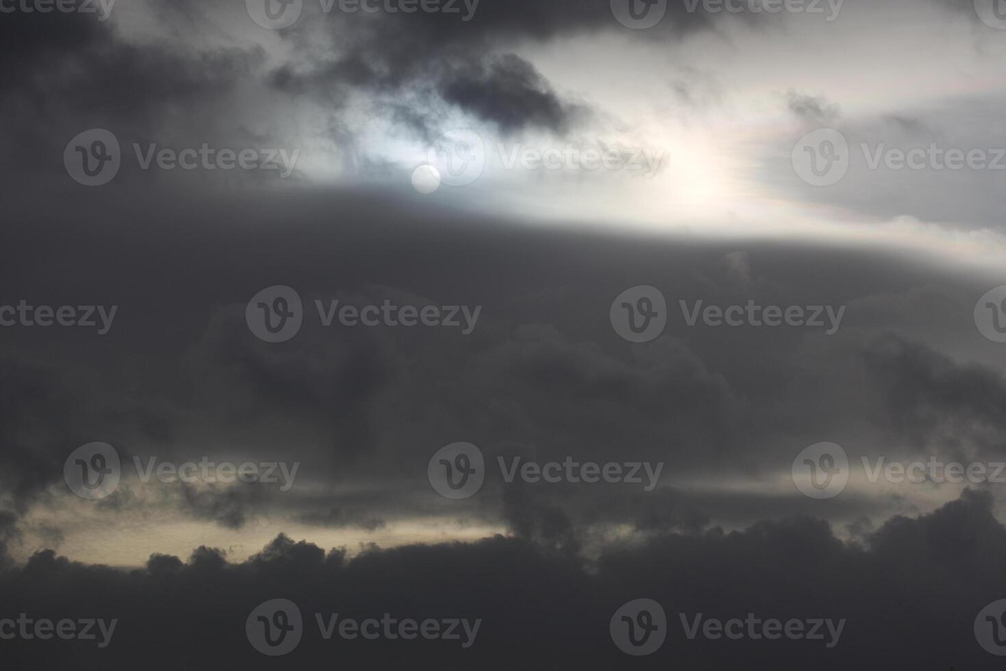 Sun shining through impressive and dense cloudscape. photo