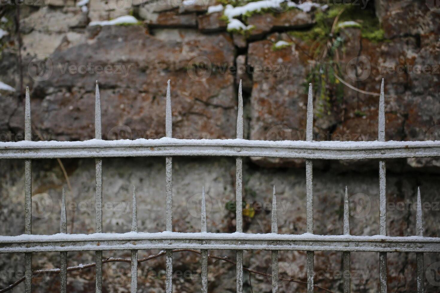 Snow of an old fashioned metal fence. photo
