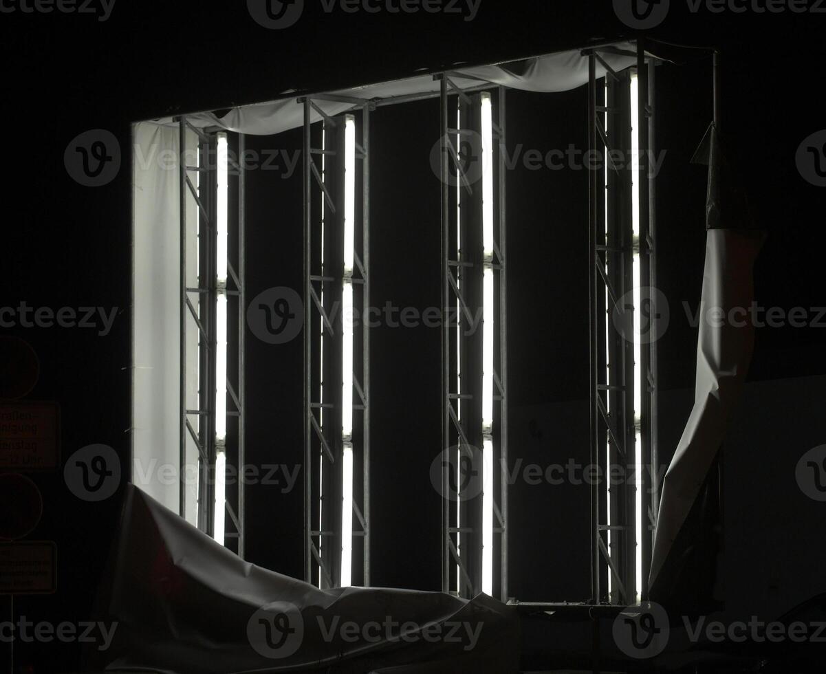 Illuminated panel ripped off showing the fluorescent tubes inside. photo