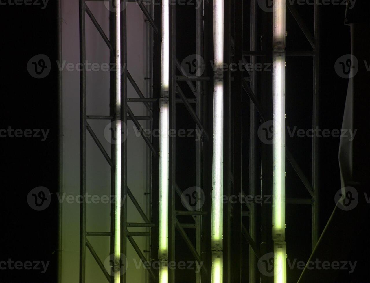Illuminated panel ripped off showing the fluorescent tubes inside. They create a red and green light effect. photo