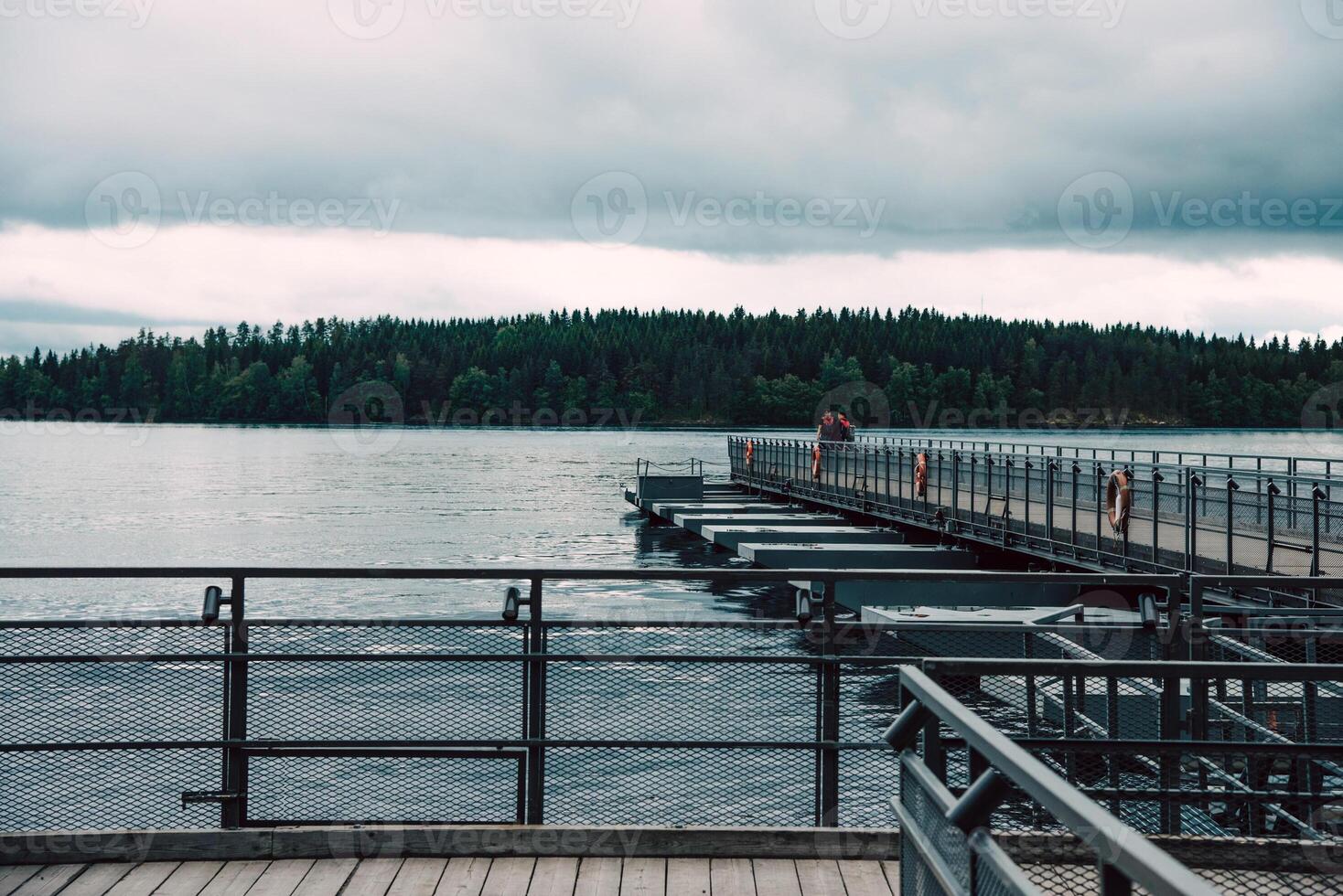 Landscape of blue tide deep lake in light of sun in daytime, clouds in sky, mountains photo
