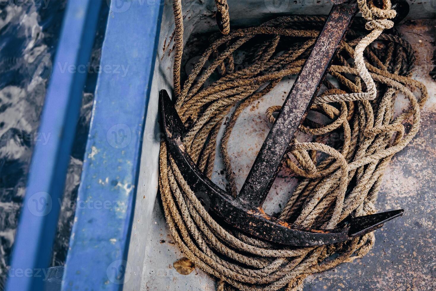 Metal anchor nice lying on board boat sailing on lake, sea vacation on ship photo